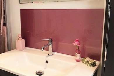 Photo of a medium sized contemporary family bathroom in Sussex with grey cabinets, a built-in bath, a shower/bath combination, a one-piece toilet and a wall-mounted sink.