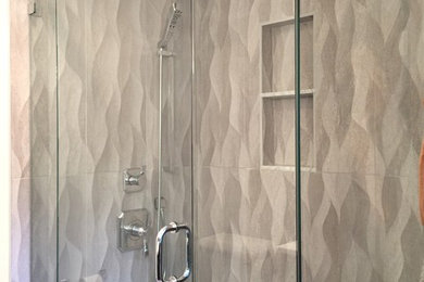 Corner shower - mid-sized contemporary master beige tile and porcelain tile porcelain tile corner shower idea in New York with flat-panel cabinets, brown cabinets, a two-piece toilet, beige walls, an integrated sink and quartzite countertops