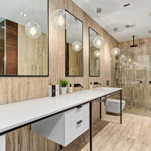 Design ideas for a mid-sized contemporary master bathroom in Melbourne with an open shower, a wall-mount toilet, travertine, travertine floors, an open shower, white benchtops, flat-panel cabinets, white cabinets, beige walls, a console sink and beige floor.