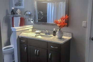 Large transitional 3/4 single-sink bathroom photo in Philadelphia with dark wood cabinets, gray walls, quartzite countertops and gray countertops