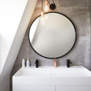 Small contemporary shower room bathroom in London with grey tiles, porcelain tiles, porcelain flooring, solid surface worktops, double sinks, a floating vanity unit, flat-panel cabinets, white cabinets, an integrated sink and white worktops.