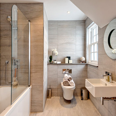 Example of a transitional beige tile and stone slab bathroom design in London with a wall-mount sink and a wall-mount toilet