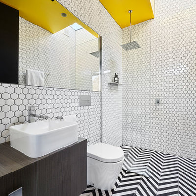 Inspiration for a contemporary 3/4 porcelain tile multicolored floor bathroom remodel in Melbourne with flat-panel cabinets, dark wood cabinets, a wall-mount toilet, white walls, a vessel sink and wood countertops