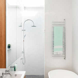Small contemporary master bathroom in Sydney with flat-panel cabinets, medium wood cabinets, a freestanding tub, an open shower, white walls, concrete floors, a console sink, grey floor, an open shower, white benchtops and white tile.