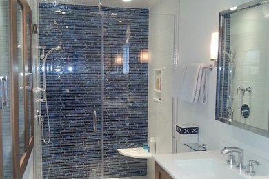 Example of a trendy white tile and porcelain tile doorless shower design in Philadelphia with an undermount sink, shaker cabinets, medium tone wood cabinets, quartz countertops and a one-piece toilet