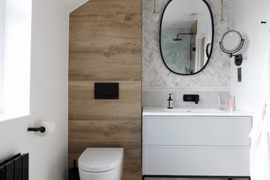 This is an example of a contemporary bathroom in London with marble tiles and marble flooring.