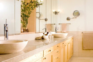 This is an example of a large modern ensuite bathroom in San Francisco with shaker cabinets, light wood cabinets, a two-piece toilet, beige tiles, ceramic tiles, beige walls, ceramic flooring, a vessel sink and quartz worktops.