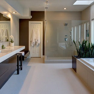 Example of a large minimalist master beige tile porcelain tile bathroom design in Houston with an undermount sink, flat-panel cabinets, dark wood cabinets, quartz countertops and white walls