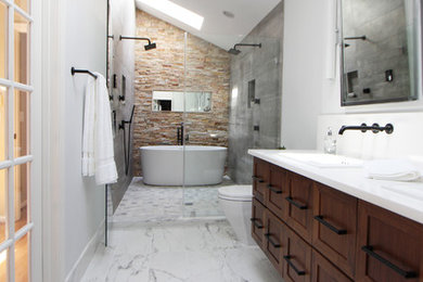 Mid-sized trendy master gray tile and porcelain tile porcelain tile and white floor bathroom photo in Atlanta with beaded inset cabinets, medium tone wood cabinets, a two-piece toilet, white walls, a drop-in sink, quartz countertops and a hinged shower door
