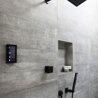 Example of a mid-sized trendy master gray tile and porcelain tile porcelain tile and white floor bathroom design in Atlanta with beaded inset cabinets, medium tone wood cabinets, a two-piece toilet, white walls, a drop-in sink, quartz countertops and a hinged shower door