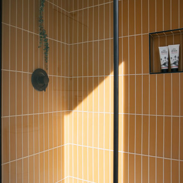 Warm Yellow Glass Tile Shower with Niche