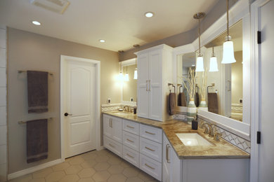 Example of a mid-sized transitional master white tile and ceramic tile ceramic tile and beige floor corner shower design in Denver with shaker cabinets, white cabinets, an undermount tub, a two-piece toilet, beige walls, an undermount sink, quartzite countertops, a hinged shower door and white countertops