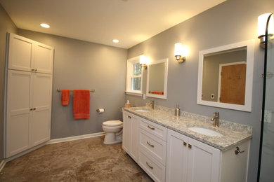 Bathroom - large transitional master ceramic tile and brown floor bathroom idea in Other with recessed-panel cabinets, white cabinets, gray walls, an undermount sink, a two-piece toilet and granite countertops