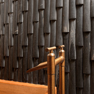 Inspiration for a mid-sized asian master black tile and stone tile porcelain tile bathroom remodel in DC Metro with white cabinets, a one-piece toilet, a vessel sink, wood countertops, flat-panel cabinets and beige walls