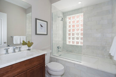 Mid-sized transitional 3/4 white tile and stone slab mosaic tile floor tub/shower combo photo in DC Metro with white walls, marble countertops, shaker cabinets, medium tone wood cabinets, a two-piece toilet and an undermount sink