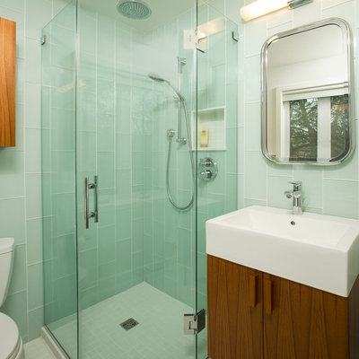 Corner shower - mid-sized eclectic 3/4 blue tile and glass tile ceramic tile corner shower idea in DC Metro with flat-panel cabinets, medium tone wood cabinets, a two-piece toilet, blue walls and a vessel sink