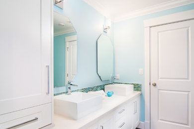 Example of a mid-sized trendy kids' multicolored tile and glass tile porcelain tile drop-in bathtub design in Vancouver with shaker cabinets, white cabinets, a two-piece toilet, blue walls, a vessel sink and quartz countertops