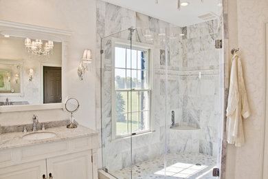 Example of a large transitional master gray tile, white tile and stone tile marble floor bathroom design in DC Metro with white cabinets, white walls, raised-panel cabinets, an undermount sink and marble countertops
