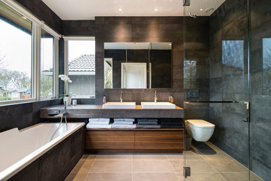 Inspiration for a mid-sized contemporary master black tile and porcelain tile porcelain tile bathroom remodel in Vancouver with flat-panel cabinets, medium tone wood cabinets, a wall-mount toilet, gray walls, an undermount sink and granite countertops