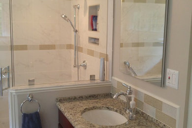 Mid-sized elegant master gray tile and porcelain tile cement tile floor bathroom photo in DC Metro with raised-panel cabinets, dark wood cabinets, a two-piece toilet, gray walls, an undermount sink and granite countertops