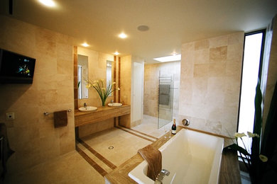Diseño de cuarto de baño clásico renovado con lavabo encastrado, armarios con paneles lisos, bañera encastrada, ducha abierta, sanitario de dos piezas, baldosas y/o azulejos de piedra y suelo de travertino