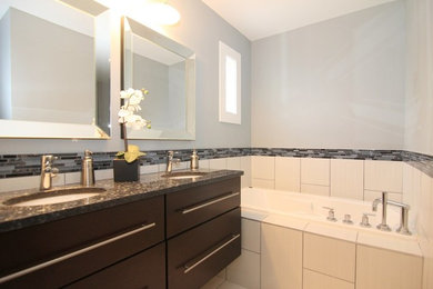 Small trendy master matchstick tile ceramic tile bathroom photo in Wichita with flat-panel cabinets, black cabinets, a two-piece toilet, blue walls, an undermount sink and granite countertops