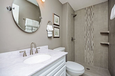Design ideas for a small classic shower room bathroom in Minneapolis with raised-panel cabinets, white cabinets, an alcove shower, a two-piece toilet, beige tiles, mosaic tiles, beige walls, mosaic tile flooring, a submerged sink, quartz worktops, white floors, a shower curtain and white worktops.