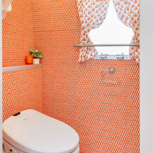 Bathroom - small eclectic 3/4 orange tile painted wood floor and orange floor bathroom idea in Los Angeles with flat-panel cabinets, white cabinets, a one-piece toilet, orange walls, an undermount sink, laminate countertops and orange countertops