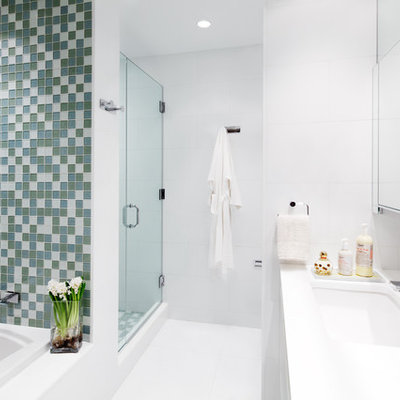 Inspiration for a large contemporary master white tile and glass tile bathroom remodel in New York with an undermount sink, flat-panel cabinets, white cabinets, a one-piece toilet and white walls