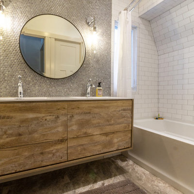 Example of a large eclectic kids' gray tile and ceramic tile ceramic tile and gray floor bathroom design in Other with furniture-like cabinets, light wood cabinets, a two-piece toilet, white walls, an integrated sink, laminate countertops and white countertops