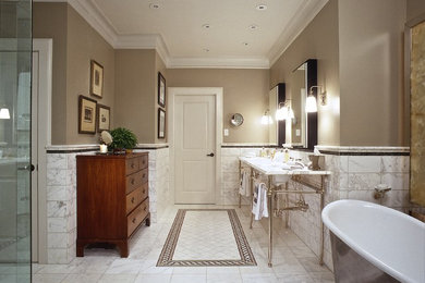 Example of a large classic master white tile and stone tile marble floor freestanding bathtub design in Houston with beige walls, dark wood cabinets, marble countertops and an undermount sink
