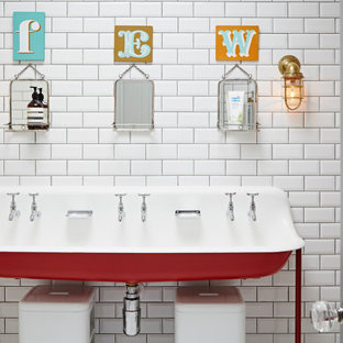 This is an example of a bohemian family bathroom in London with red cabinets, white tiles, metro tiles, a freestanding vanity unit, a trough sink and a single sink.
