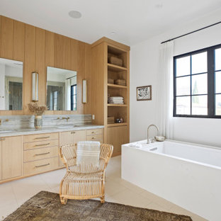 Idéer för ett stort klassiskt grå en-suite badrum, med luckor med infälld panel, beige skåp, ett fristående badkar, våtrum, en toalettstol med hel cisternkåpa, vit kakel, travertinkakel, vita väggar, kalkstensgolv, ett undermonterad handfat, bänkskiva i kalksten, beiget golv och dusch med gångjärnsdörr