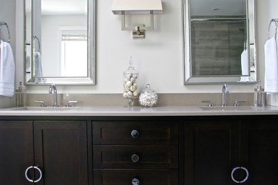 Photo of a classic bathroom in Montreal with shaker cabinets, dark wood cabinets, beige walls, porcelain flooring, a submerged sink and engineered stone worktops.