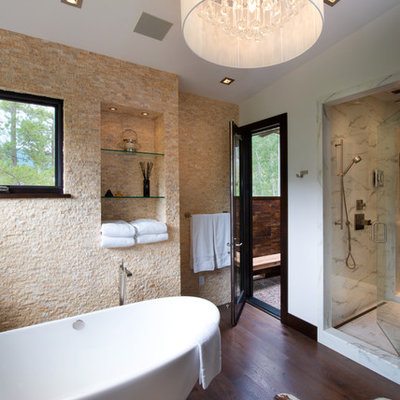 Inspiration for a large rustic master beige tile and stone tile dark wood floor bathroom remodel in Denver with white walls, flat-panel cabinets, dark wood cabinets and granite countertops