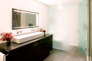 Trendy concrete floor and gray floor alcove shower photo in Vancouver with beige walls, a vessel sink and a hinged shower door
