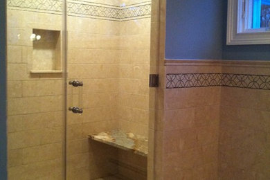 Large elegant master beige tile and stone tile marble floor alcove shower photo in New York with beige walls
