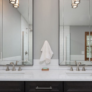Mid-sized transitional master white tile and ceramic tile mosaic tile floor and white floor bathroom photo with shaker cabinets, dark wood cabinets, a two-piece toilet, gray walls, an undermount sink and marble countertops
