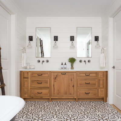 Inspiration for a cottage freestanding bathtub remodel in New York with shaker cabinets, medium tone wood cabinets and white walls