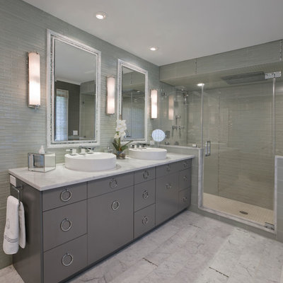 Mid-sized trendy master marble floor and white floor alcove shower photo in New York with a vessel sink, gray cabinets, flat-panel cabinets, a two-piece toilet, gray walls, marble countertops and a hinged shower door