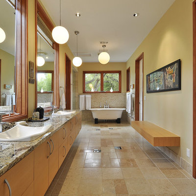 Inspiration for a contemporary freestanding bathtub remodel in Austin with granite countertops and a drop-in sink