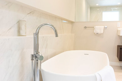Example of a large trendy master white tile and porcelain tile marble floor and white floor bathroom design in New York with flat-panel cabinets, dark wood cabinets, a bidet, white walls, an integrated sink, solid surface countertops and white countertops