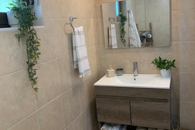 Photo of a small contemporary bathroom in Other with flat-panel cabinets, dark wood cabinets, beige tiles, ceramic tiles, beige walls, ceramic flooring, an integrated sink, beige floors, an open shower, a single sink and a floating vanity unit.
