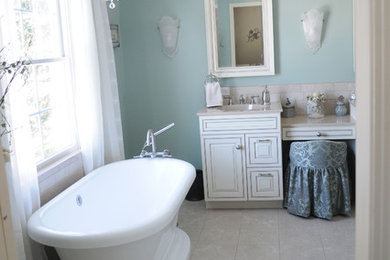 Inspiration for a large transitional master ceramic tile and gray floor freestanding bathtub remodel in Cleveland with raised-panel cabinets, white cabinets, green walls and an undermount sink