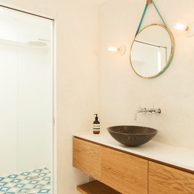 Inspiration for a small scandinavian master walk-in shower remodel in London with flat-panel cabinets, medium tone wood cabinets, quartzite countertops, a vessel sink and white walls