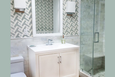 Small transitional 3/4 gray tile, white tile and stone tile bamboo floor alcove shower photo in New York with furniture-like cabinets, white cabinets, multicolored walls, an integrated sink, solid surface countertops and a hinged shower door