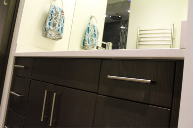 This is an example of a medium sized contemporary ensuite bathroom in Vancouver with a submerged sink, flat-panel cabinets, dark wood cabinets, engineered stone worktops, an alcove shower, a two-piece toilet, beige walls and porcelain flooring.