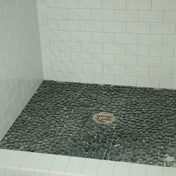 White 3 x 6 subway shower with pebble floor