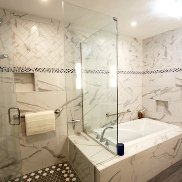 White and Gray MasterBath with Marble Look and Herringbone Tiled Shower