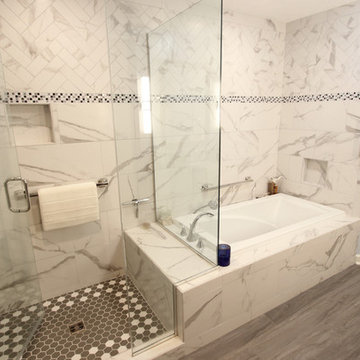 White and Gray MasterBath with Marble Look and Herringbone Tiled Shower